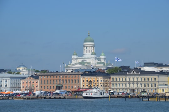 white and brown concrete building near body of water during daytime in Helsinki Cathedral Finland