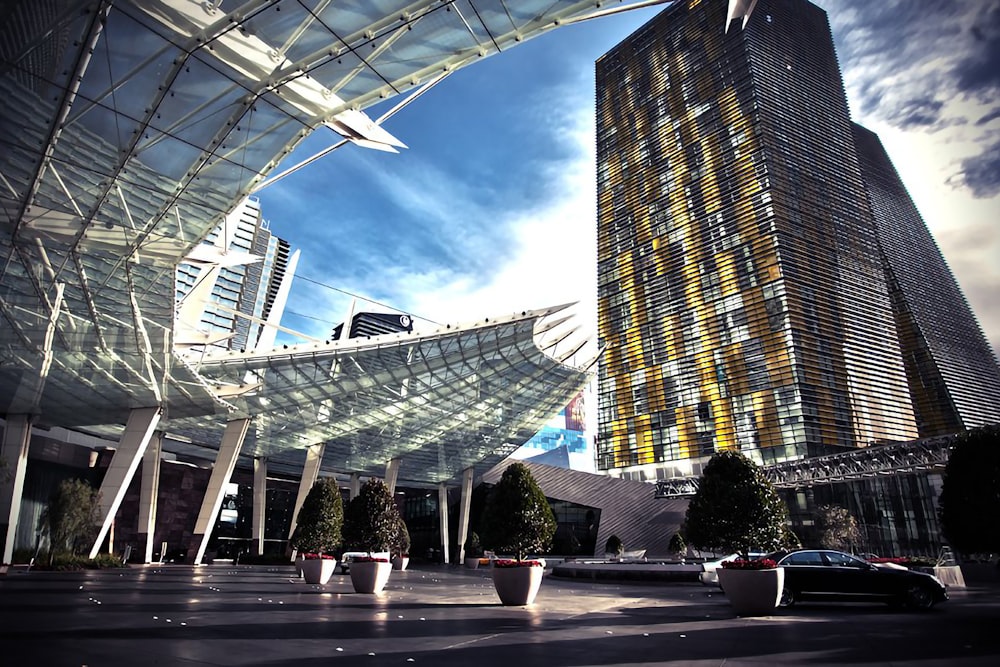 people walking on sidewalk near high rise building during daytime