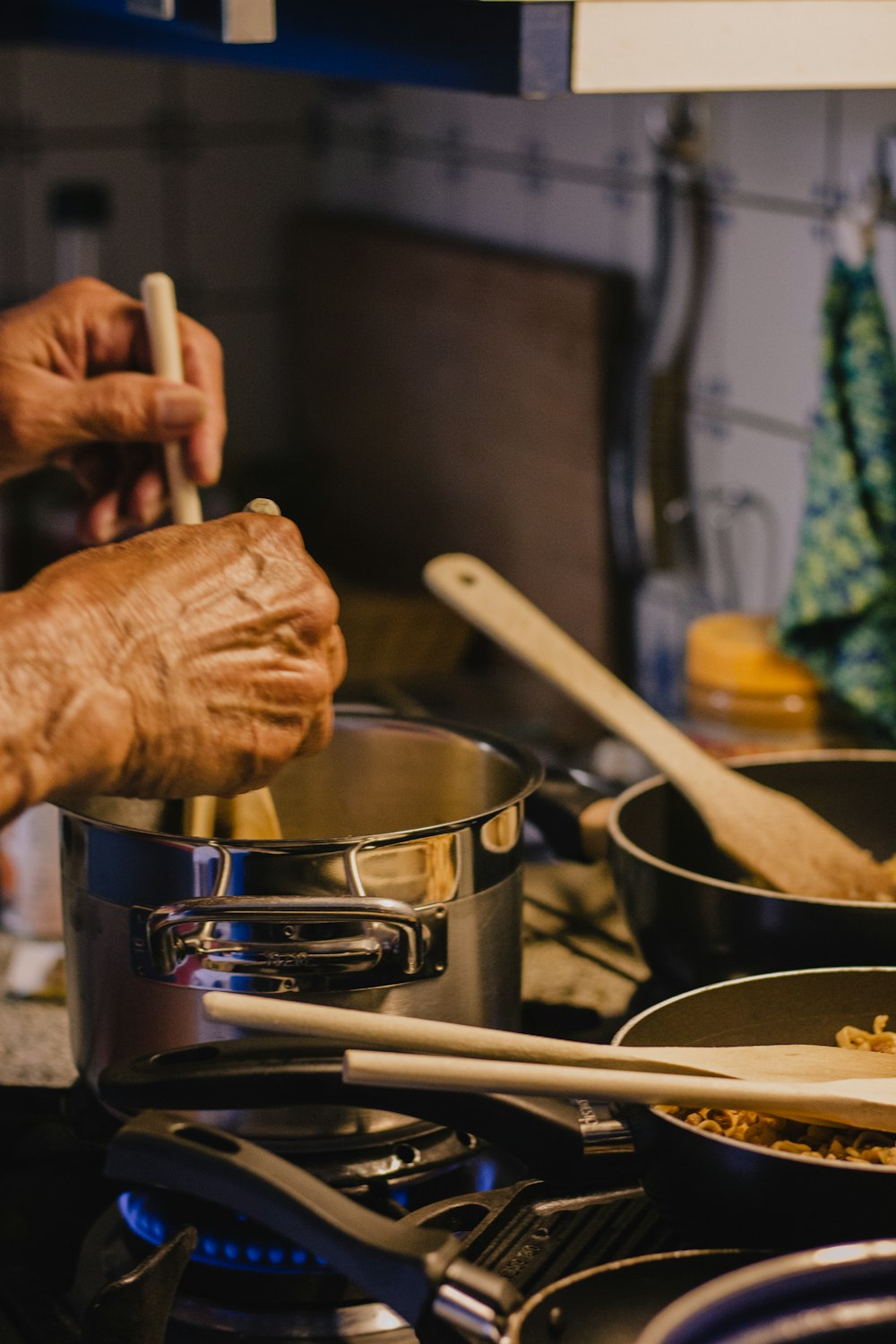 person holding brown wooden rolling pin