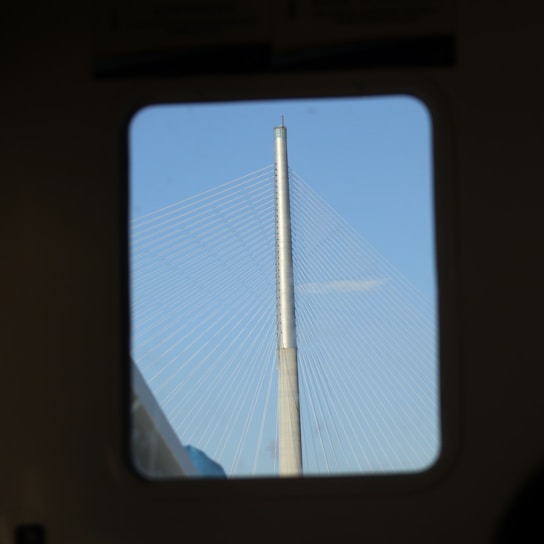 Technicians installing network equipment with Sydney Harbour Bridge in the background on a bright day.
