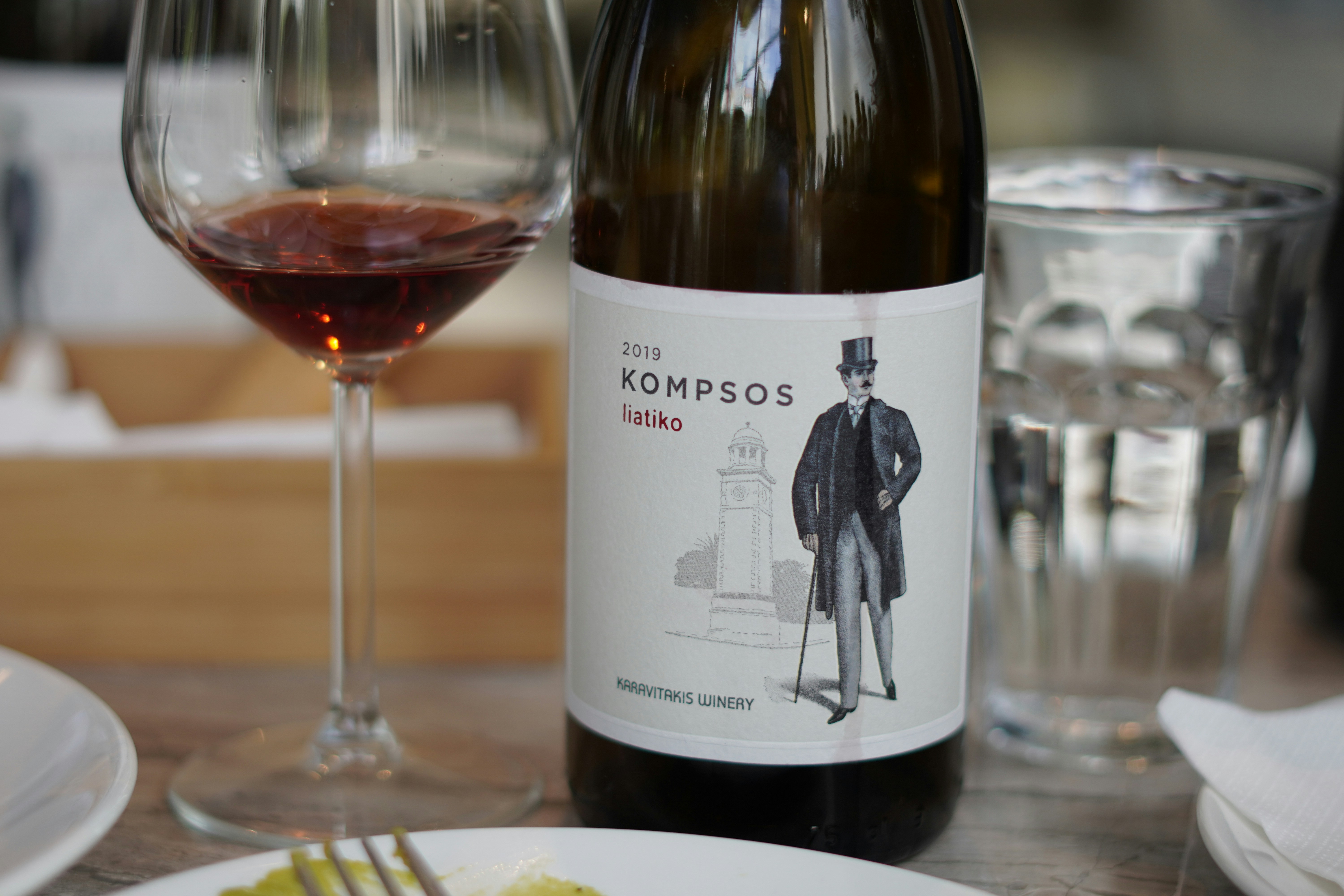 white and black labeled bottle, Wine bottle at restaurant