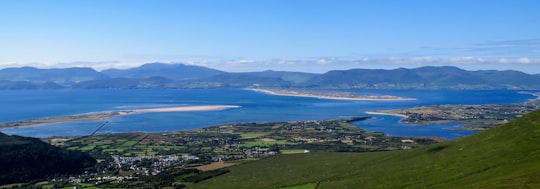 aerial view of green grass field near body of water during daytime in Seefin Ireland