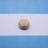 gold round coin on white paper