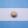 gold round coin on white paper