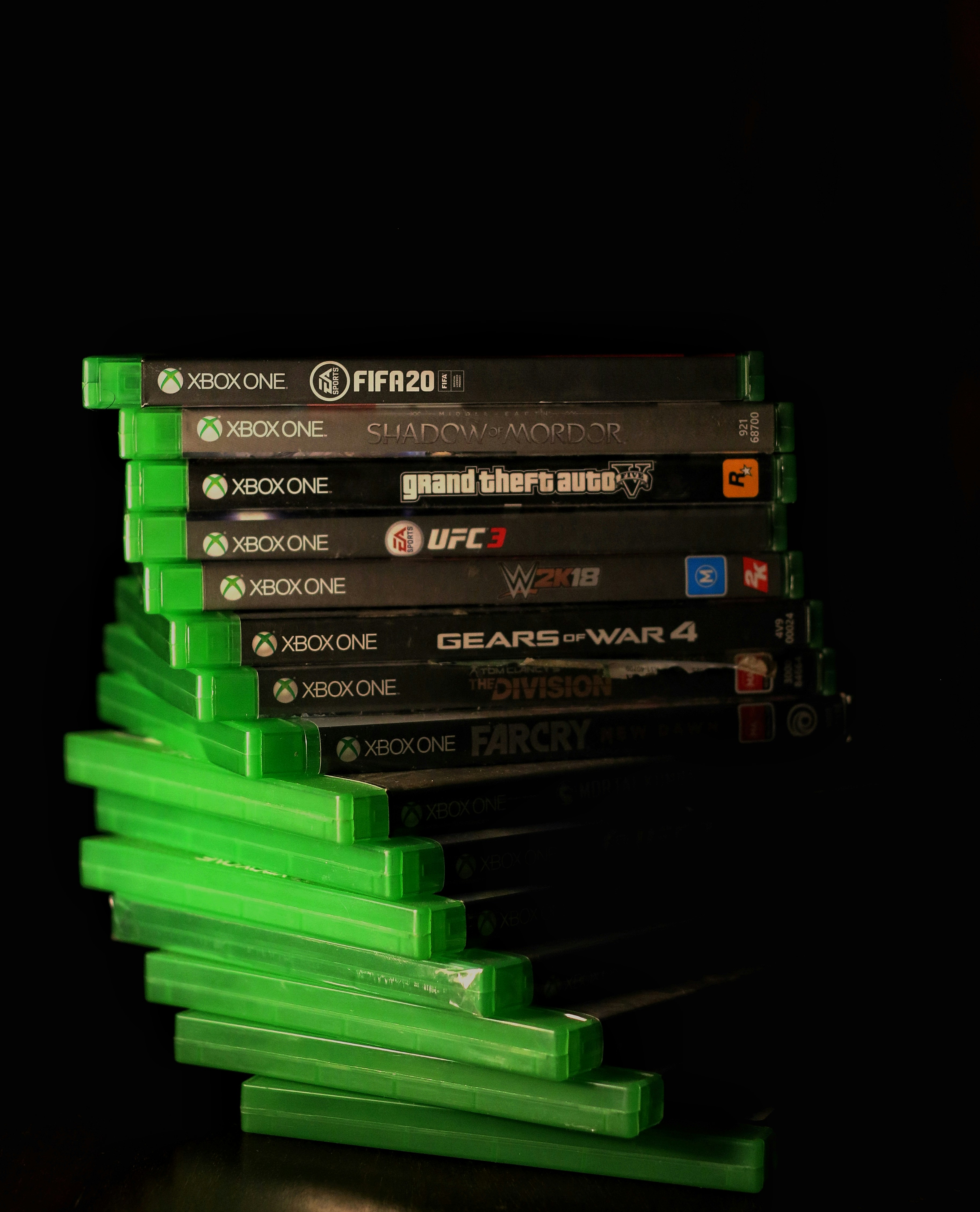 Collection of PS5 game cases on dark background with colorful lighting