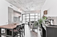 A finished residential remodel featuring modern kitchen and open living space.