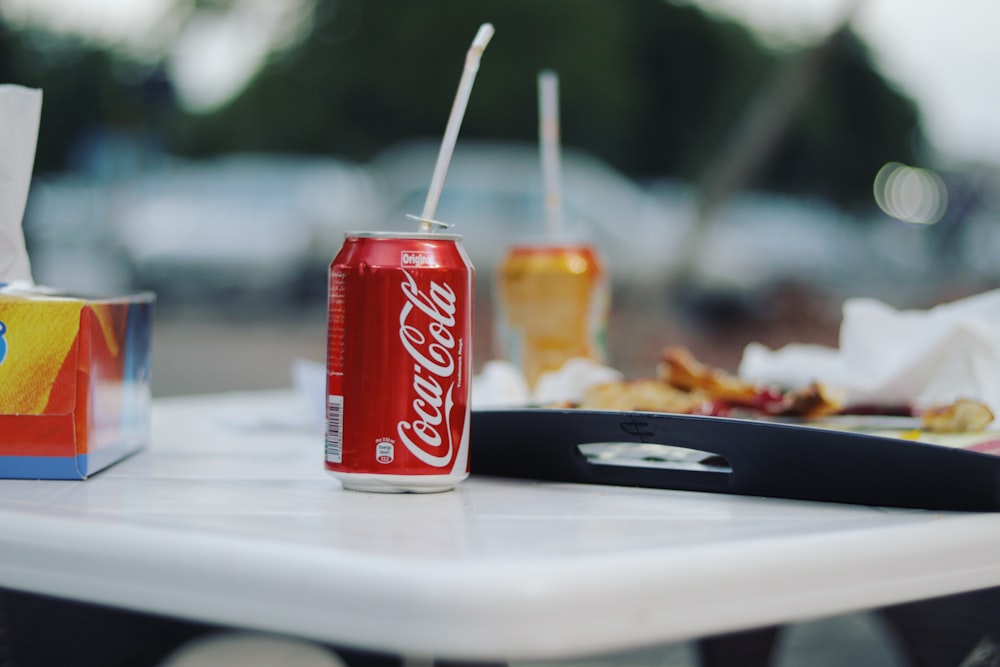 coca cola can on white ceramic plate