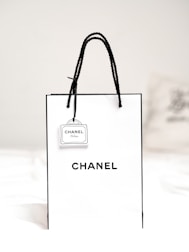 black leather sling bag on white textile