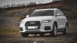 white audi a 4 on dirt road during daytime