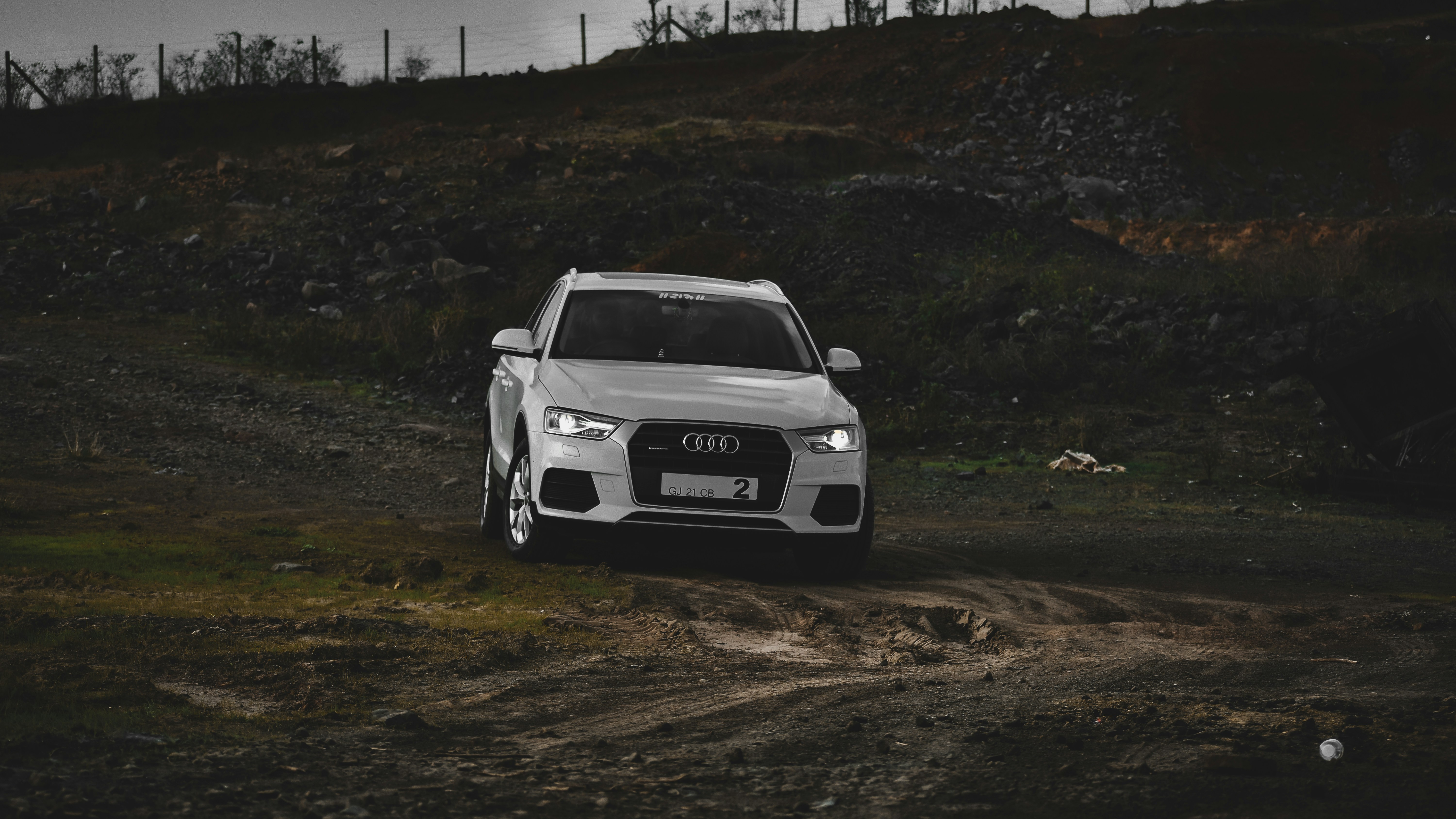 white and black bmw m 3 on dirt road during daytime