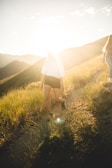 Outdoor shot of a woman enjoying a peaceful walk in nature during golden hour.