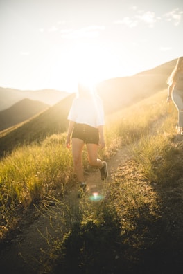 Outdoor shot of a woman enjoying a peaceful walk in nature during golden hour.