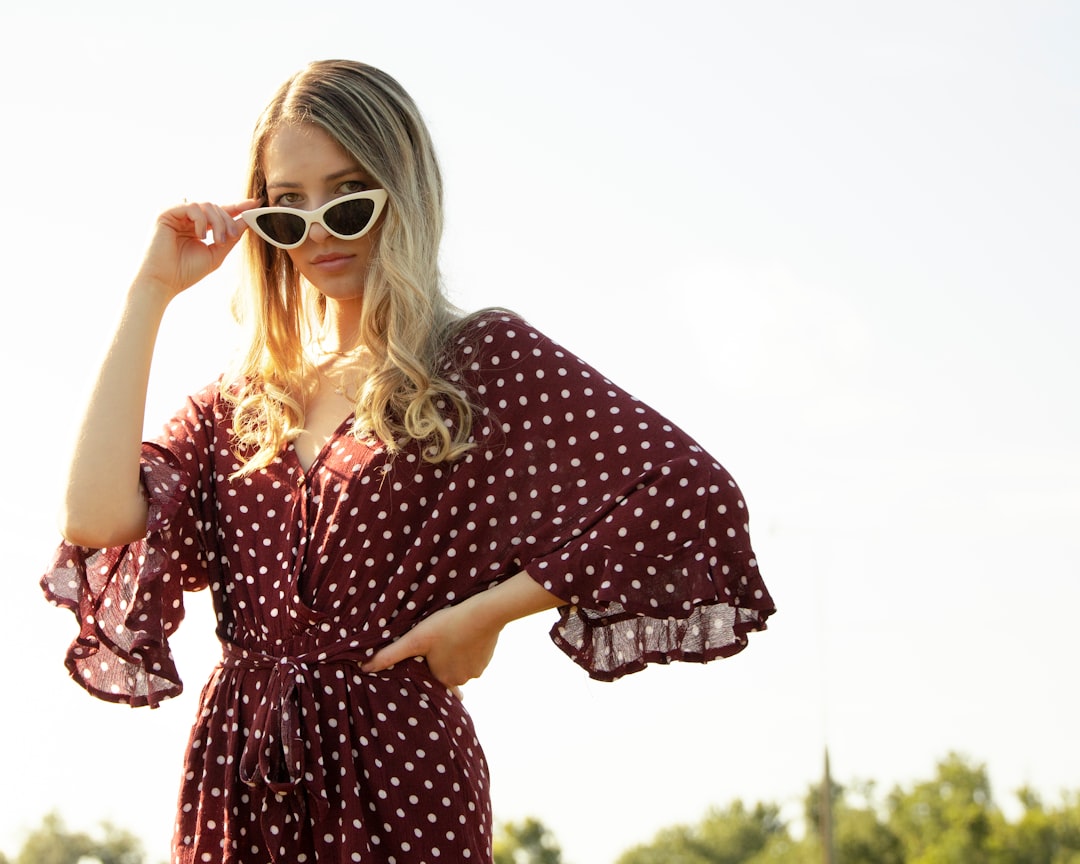 woman in black and red polka dot dress wearing sunglasses