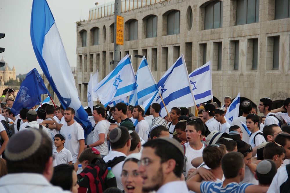 people gathering in front of building during daytime