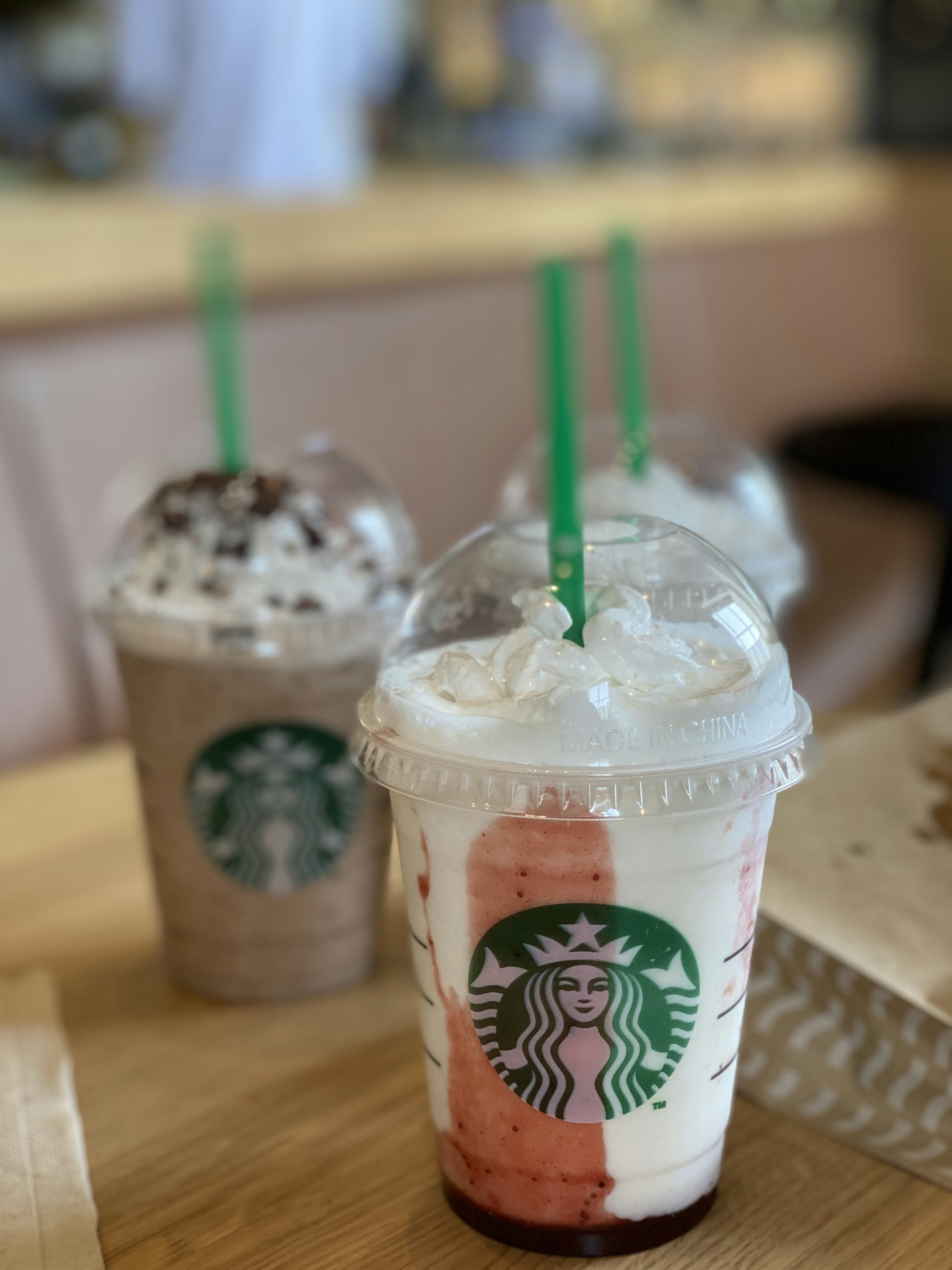 white and green starbucks disposable cup