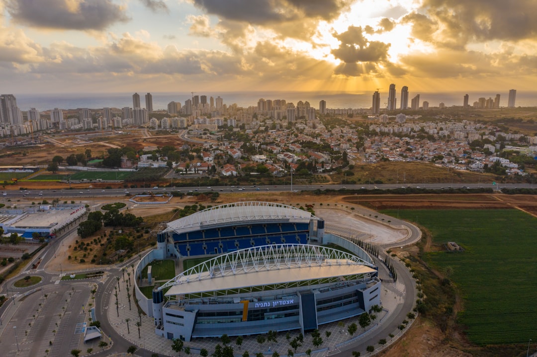 white and blue stadium under cloudy sky during daytime