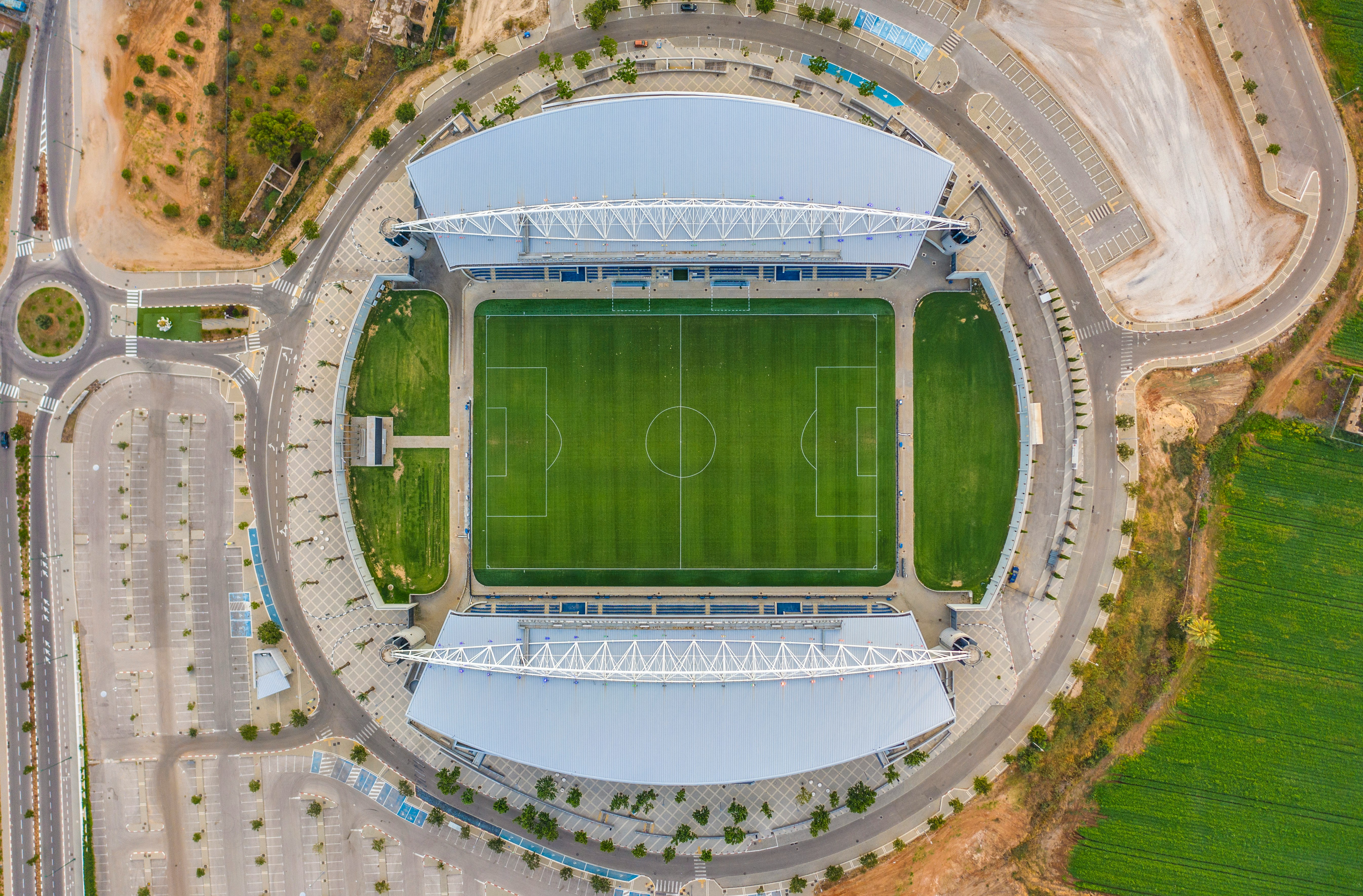 aerial view of green and white stadium during daytime