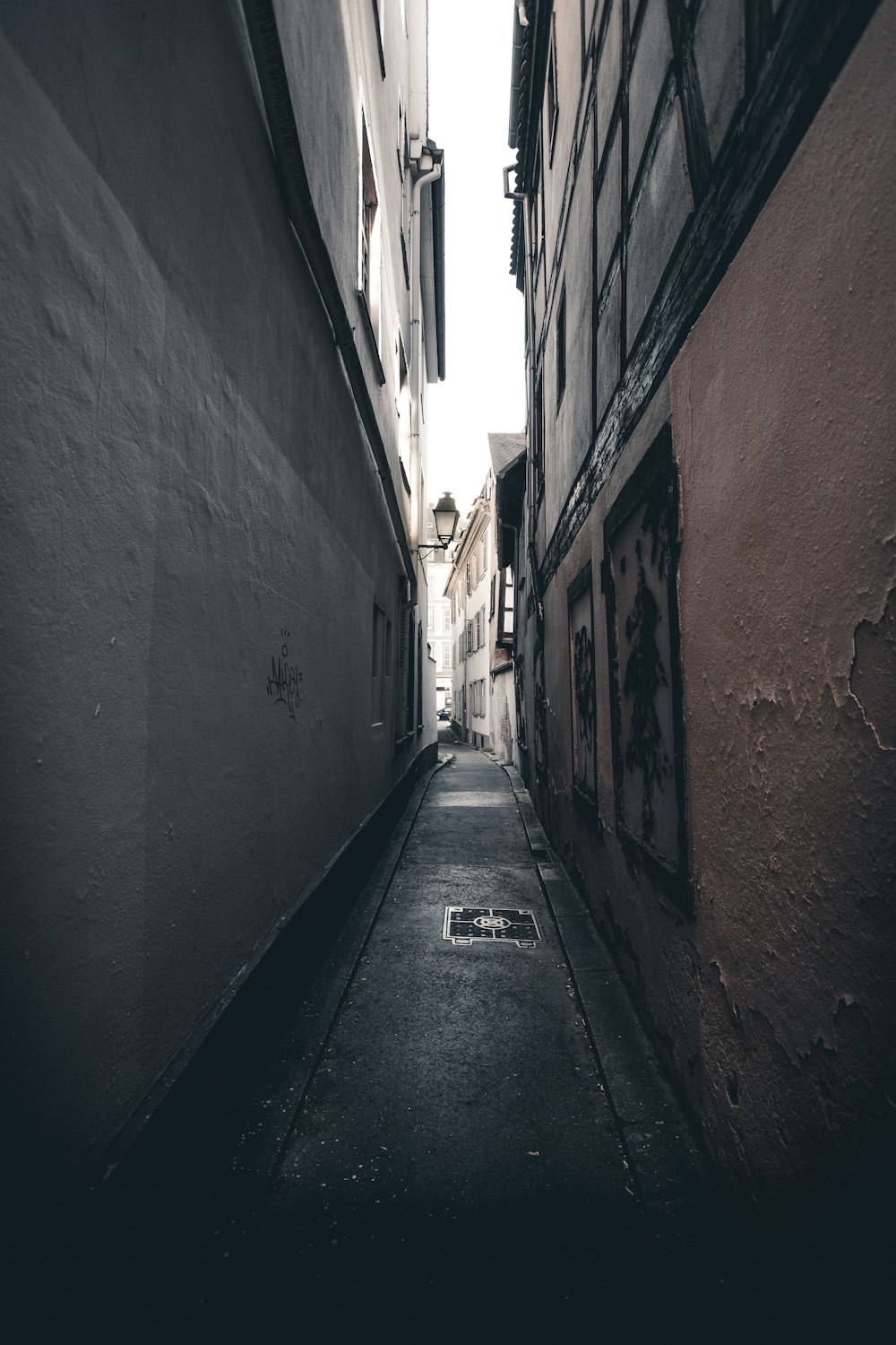 empty hallway between brown brick wall