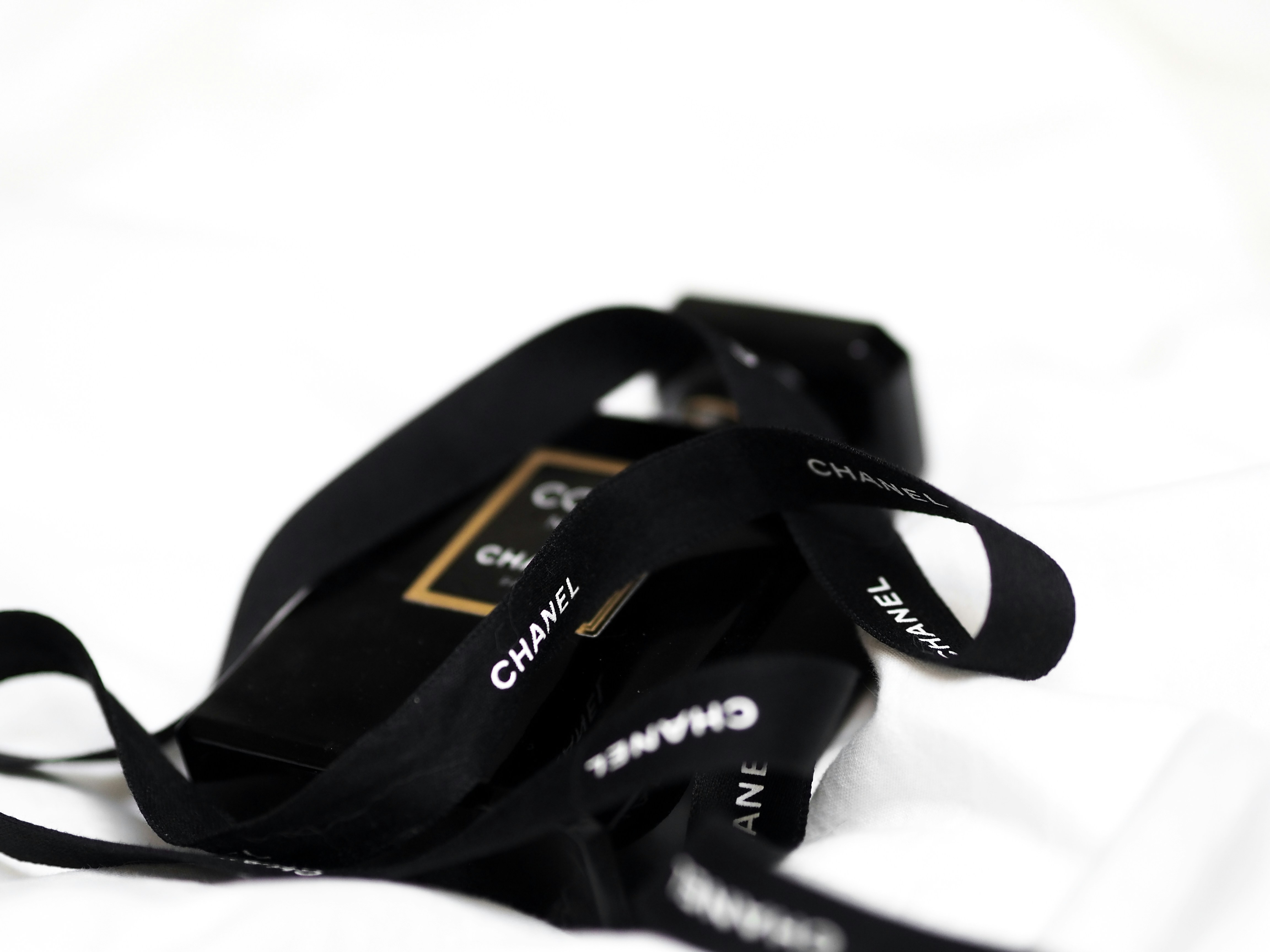 A black lanyard laid on a white sheet