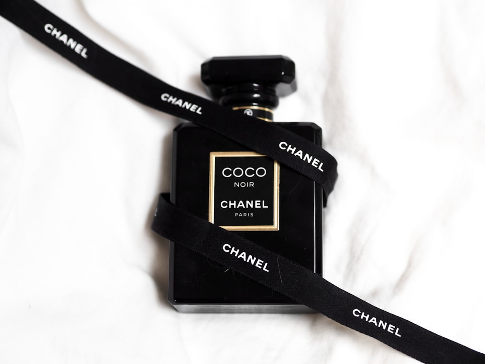 a chanel bottle with a black lanyard around it