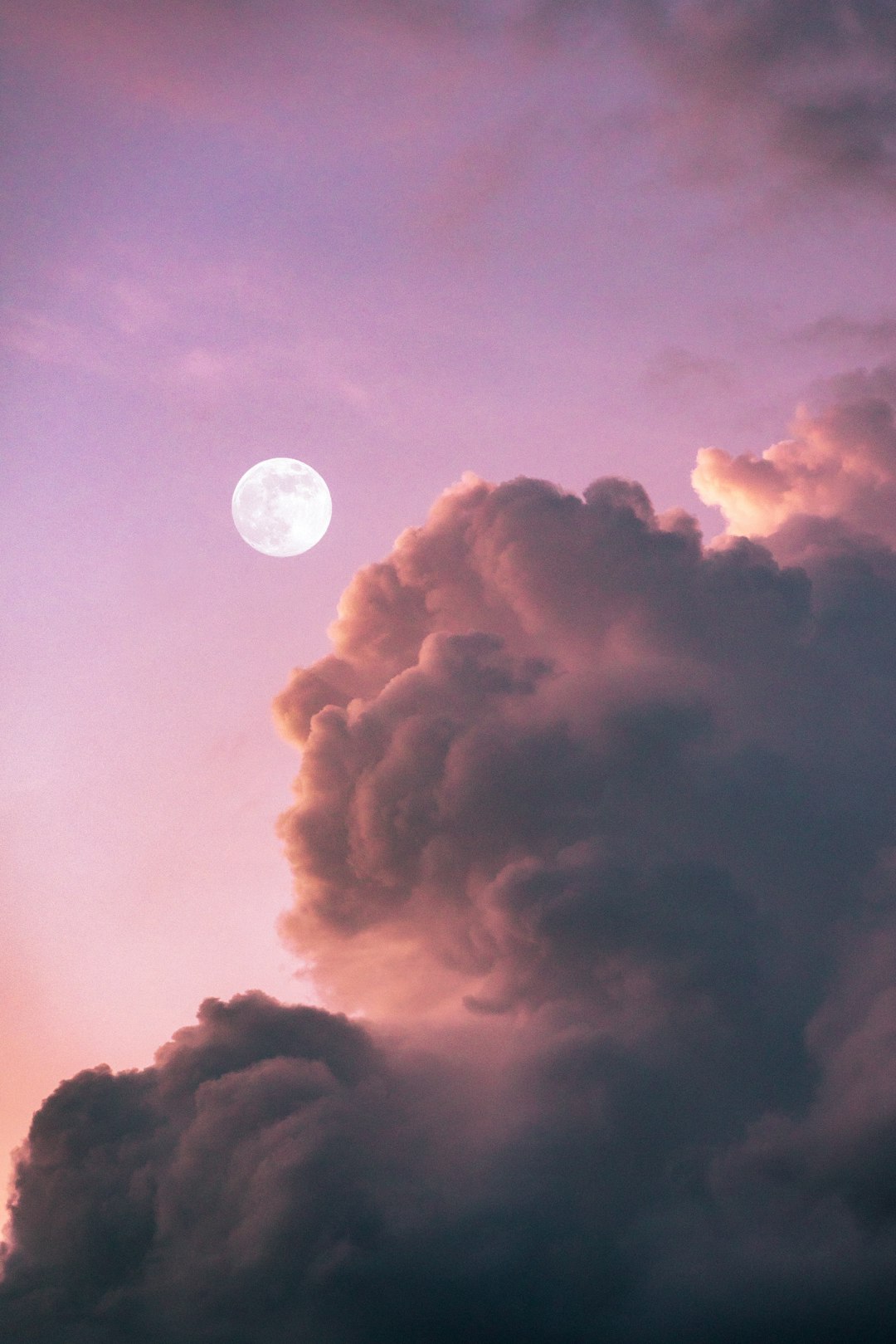 full moon over clouds during night time