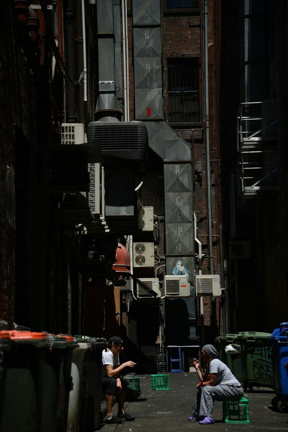 cars parked on the side of the road in between buildings during daytime