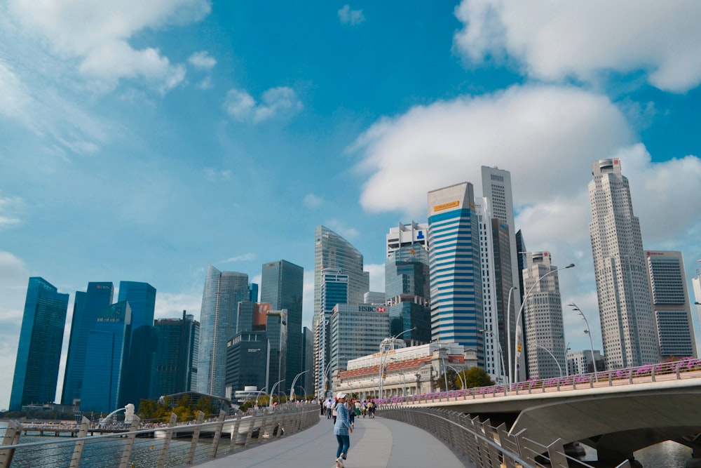 people walking on sidewalk near city buildings during daytime