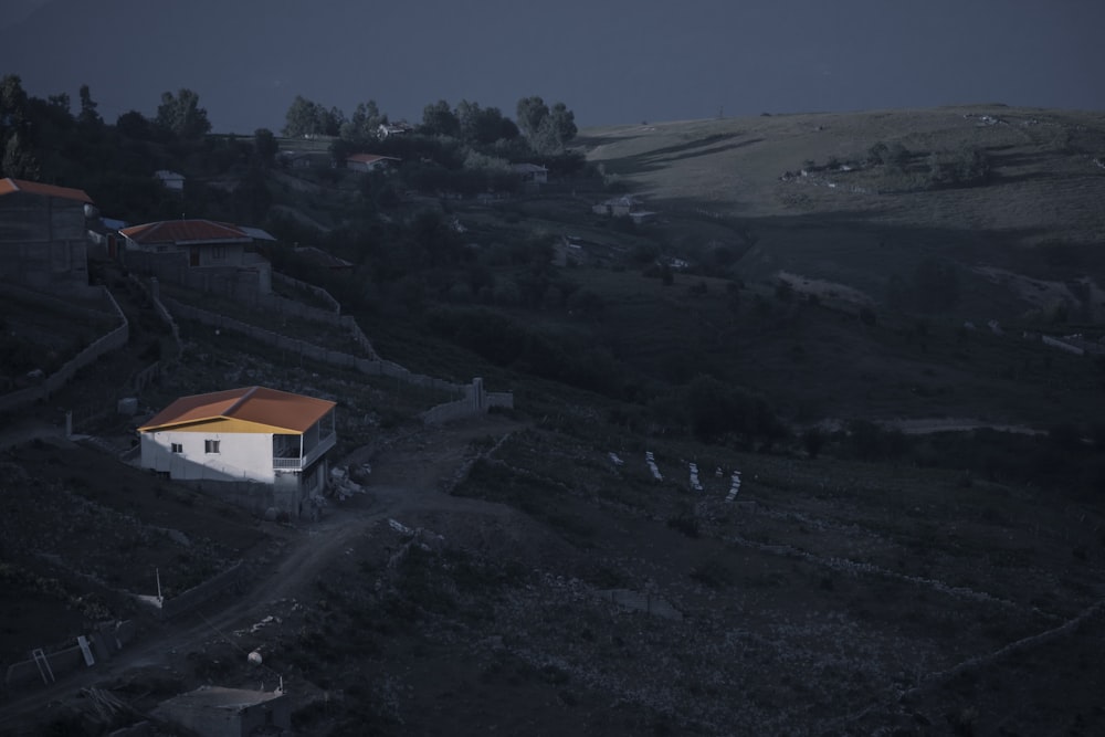 white and brown house on top of hill