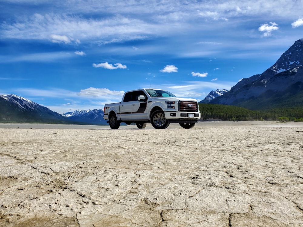 white suv on dirt road during daytime