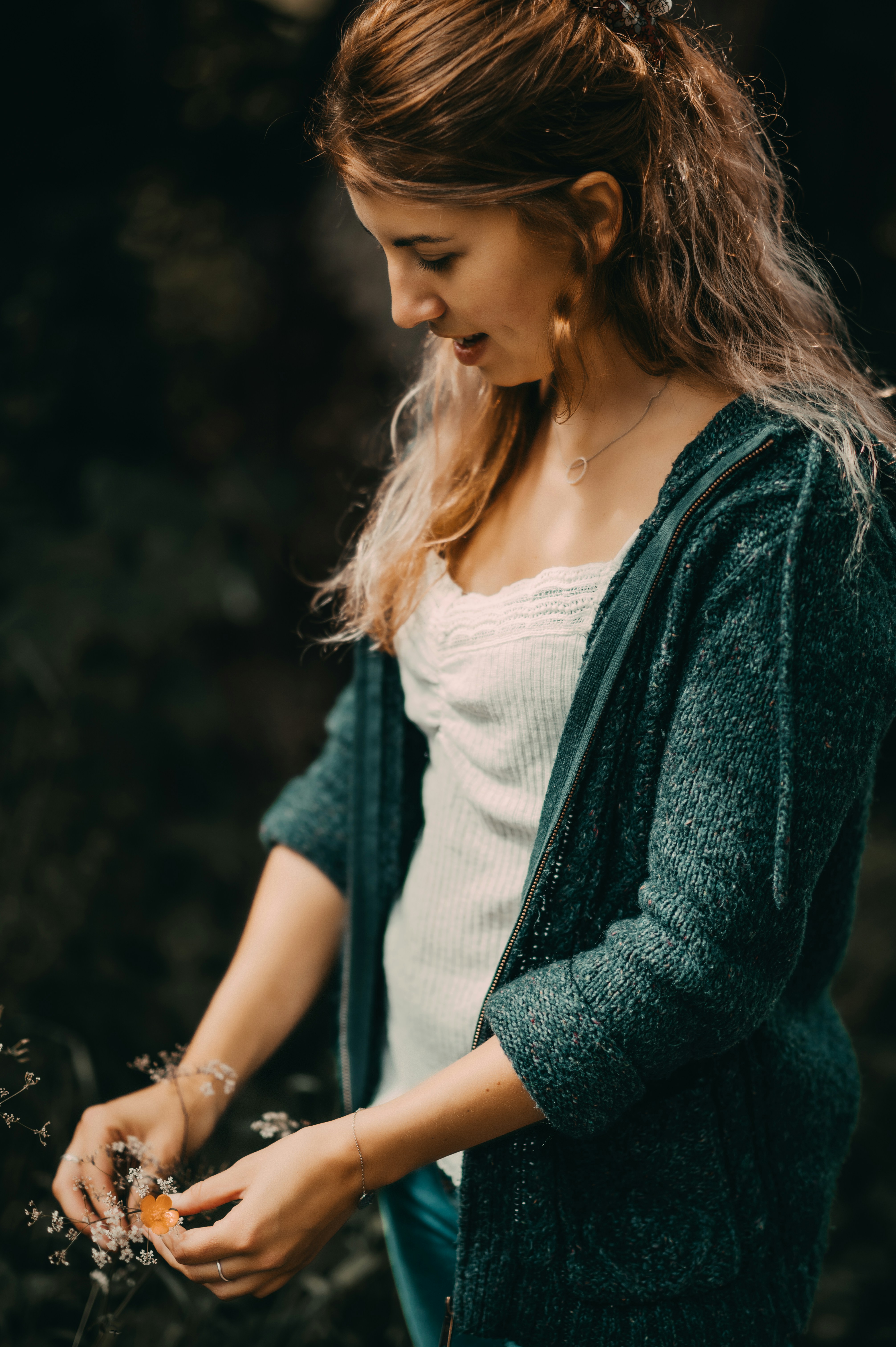 woman in white tank top and green cardigan