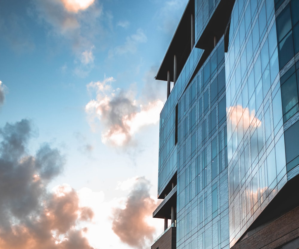 black and white building under white clouds