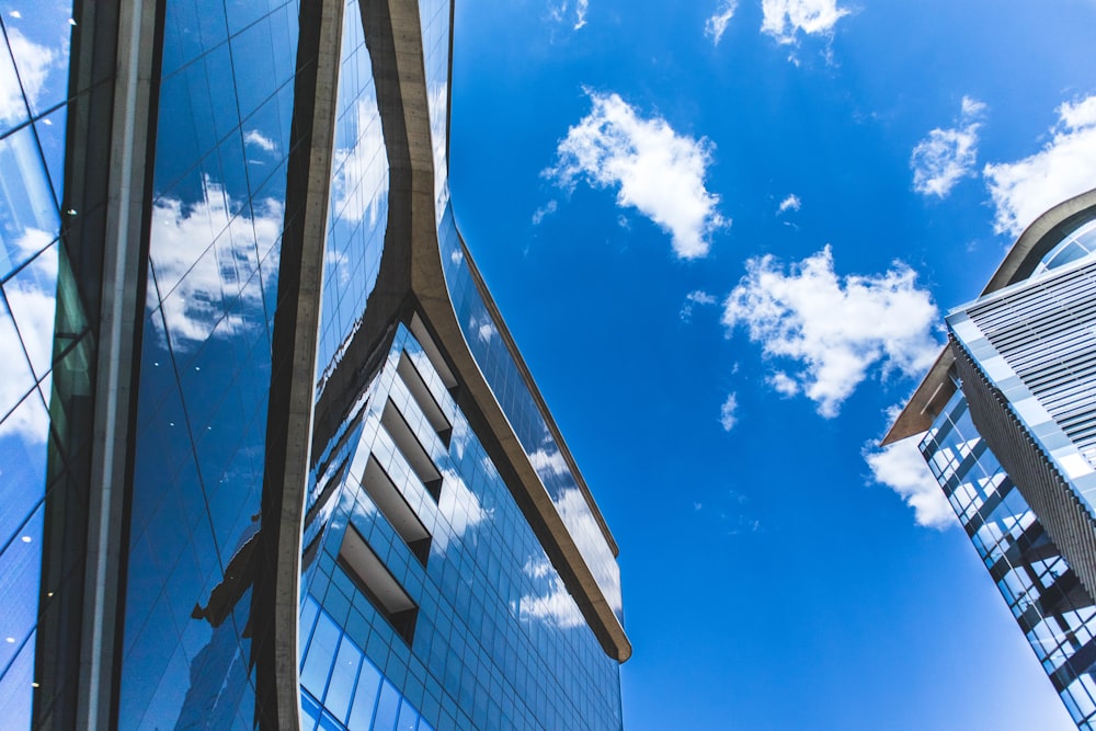 white clouds over blue and white building