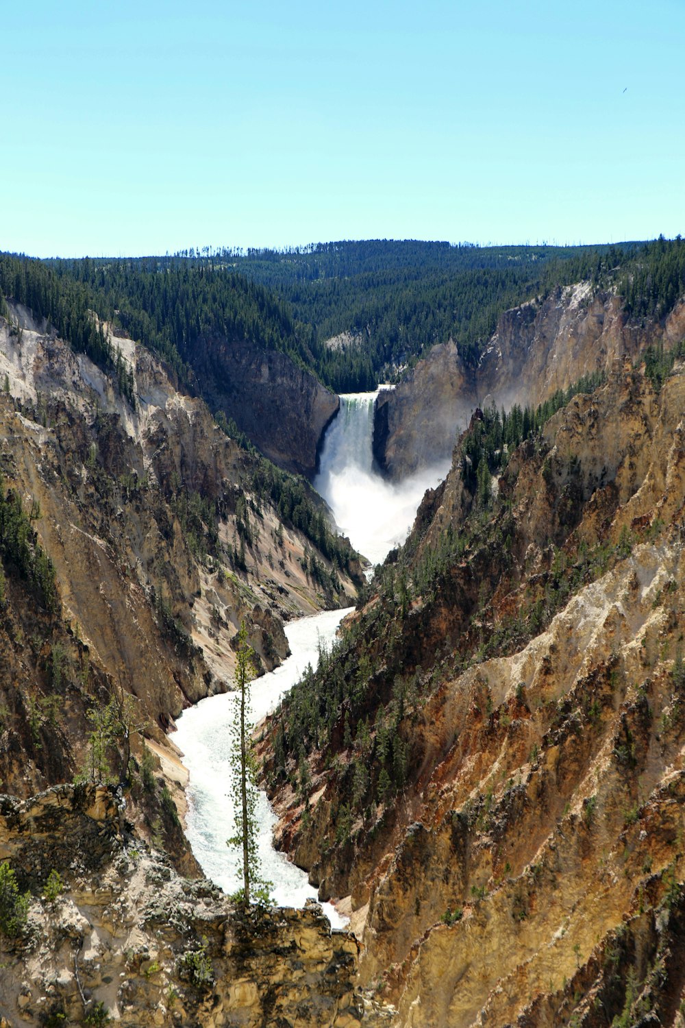 green and brown mountains with waterfalls