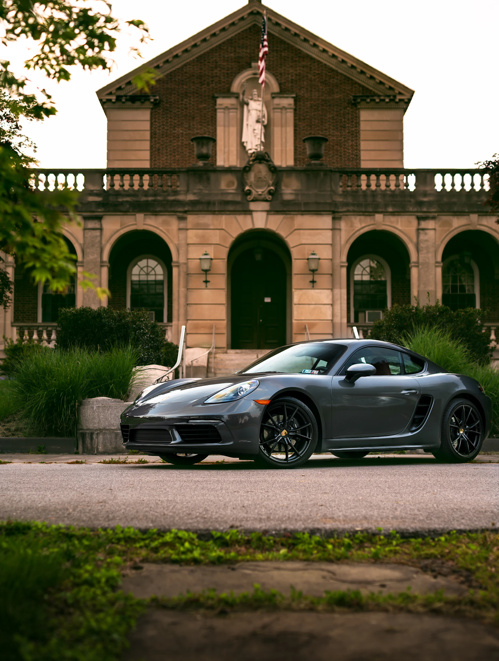 Luxury coupe parked beside a modern concrete building