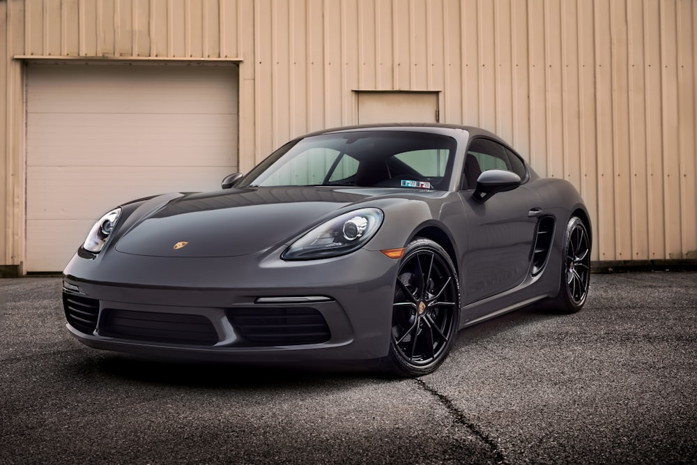 black porsche 911 parked near white wall