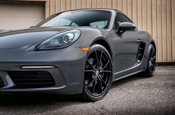 black mercedes benz coupe parked on gray asphalt road during daytime