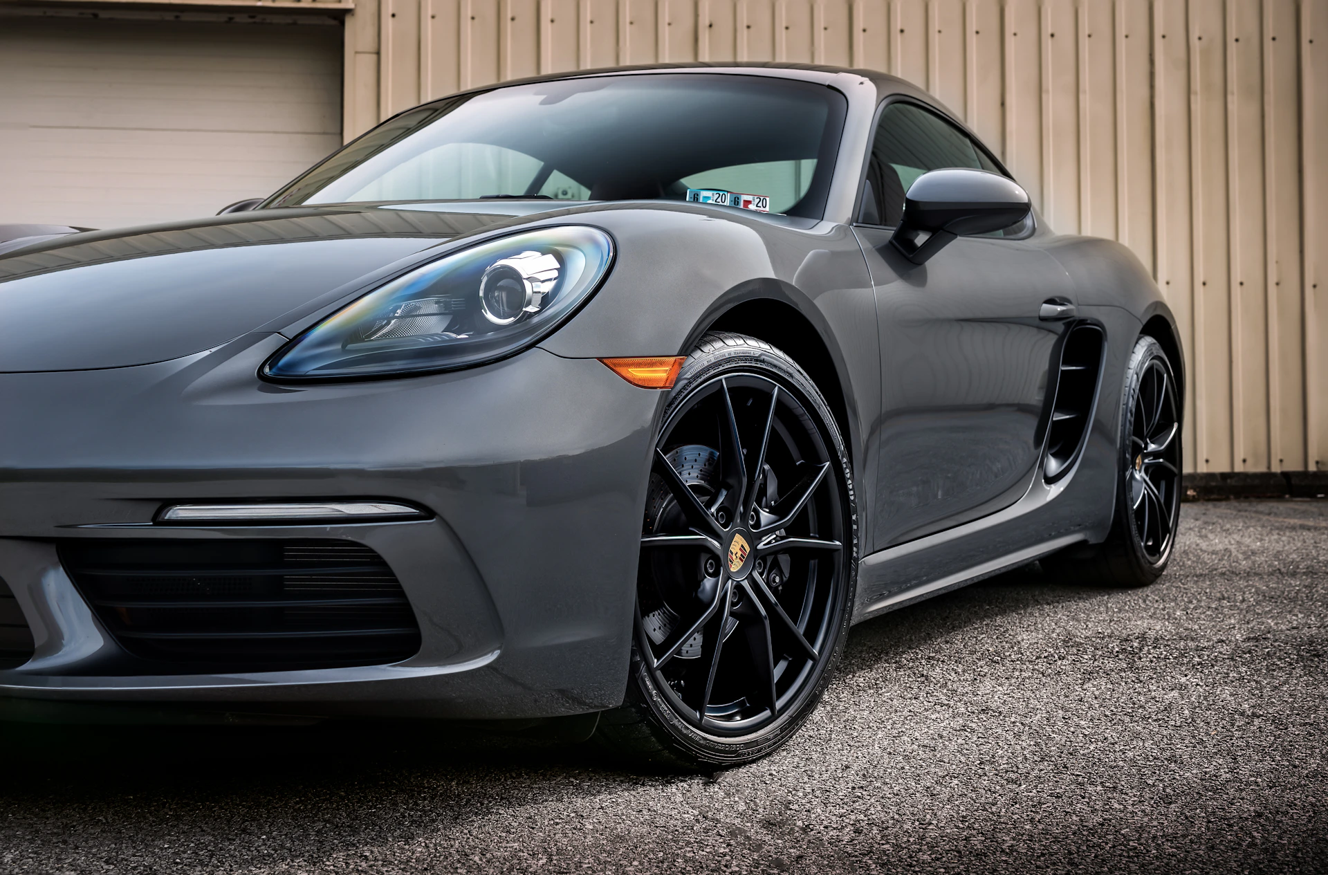black mercedes benz coupe parked on gray asphalt road during daytime