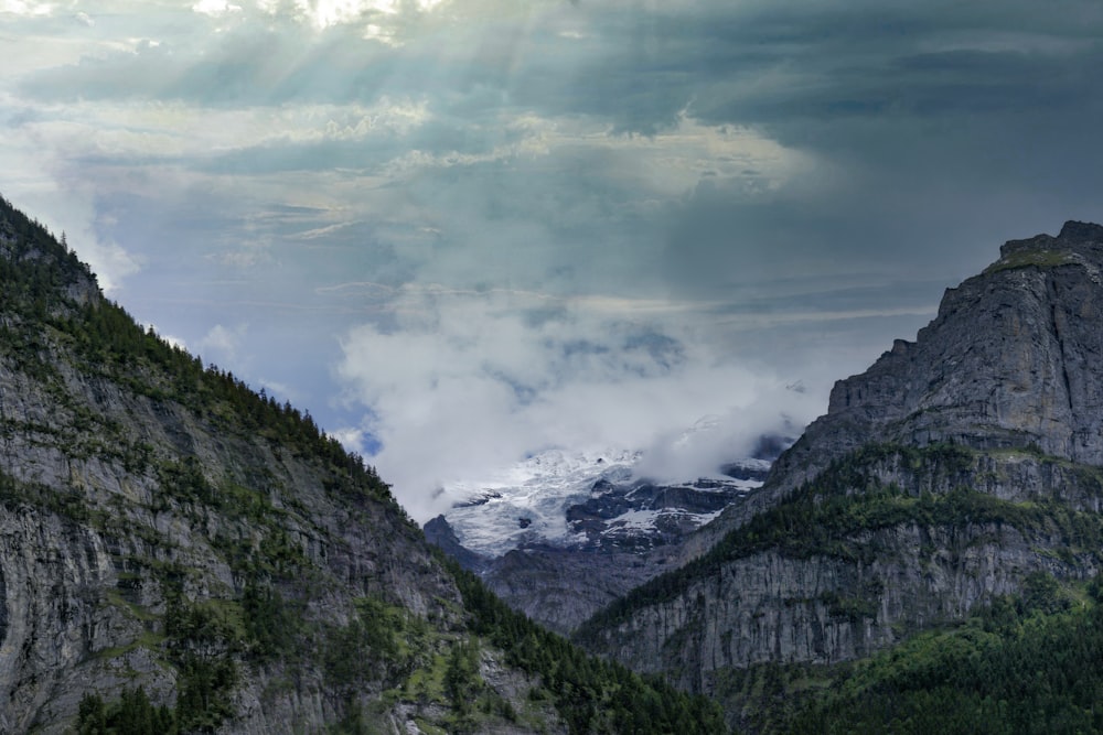 green and black mountains under white clouds