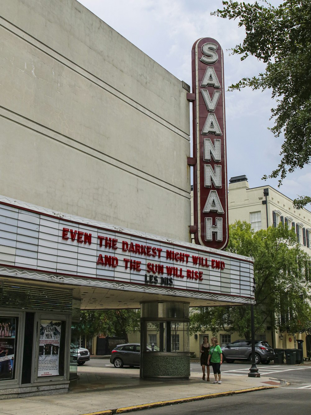 a theater marquee that says even the darker night has come and the sun