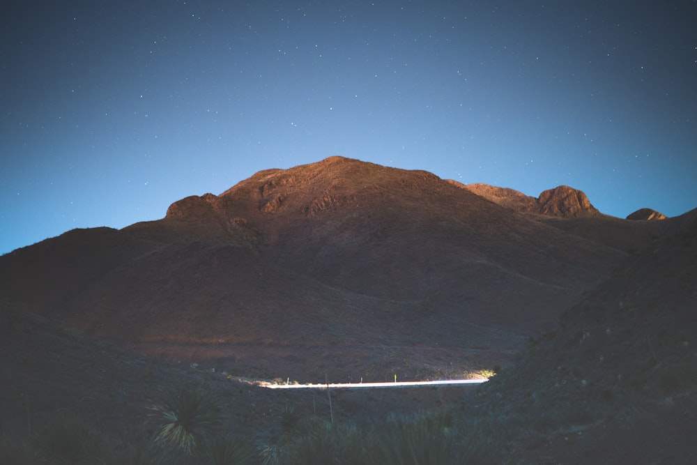 brown mountain under blue sky during night time