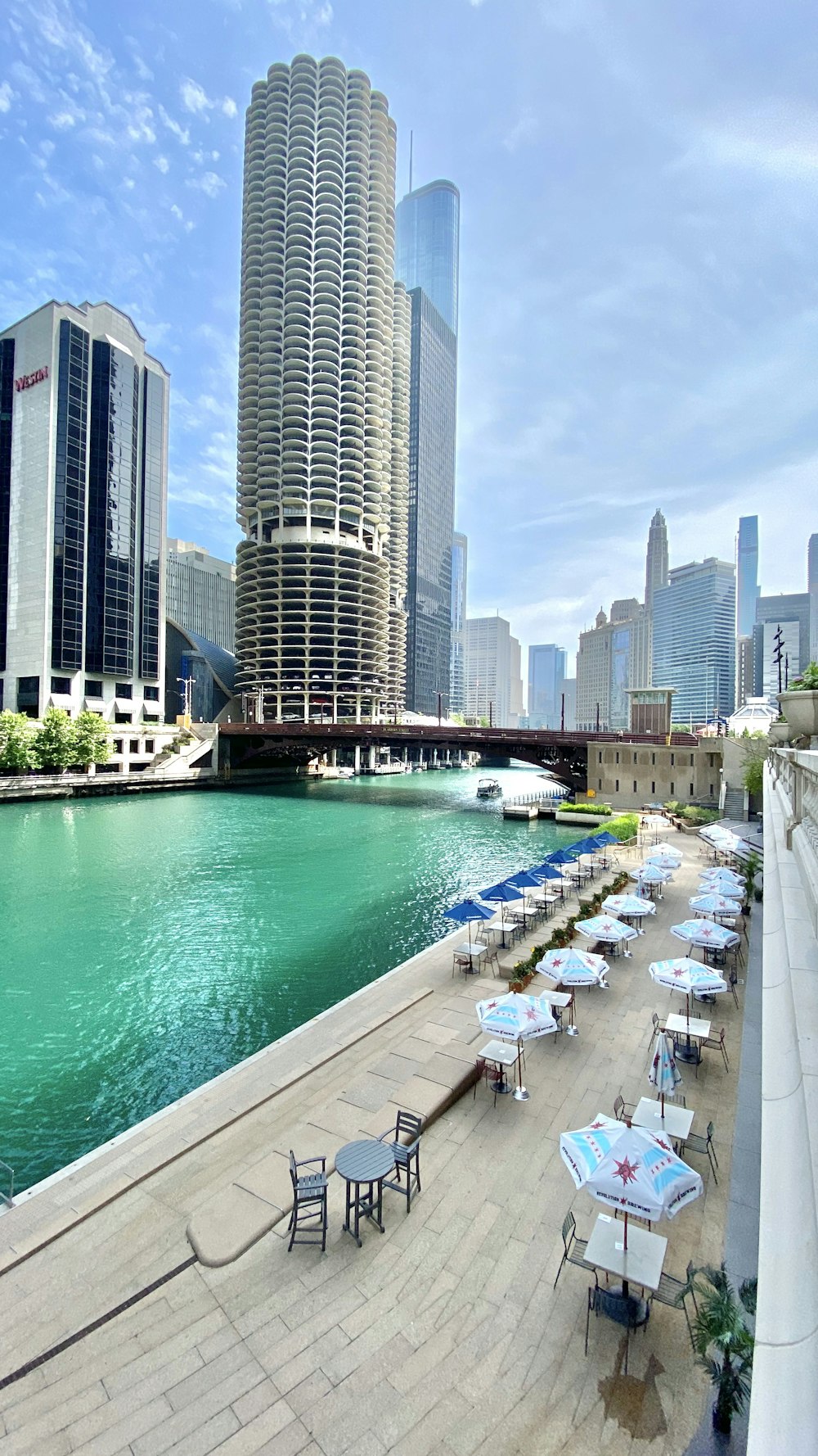 white and blue boat on water near city buildings during daytime