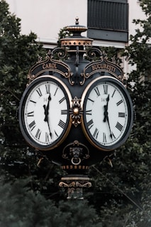 black and white analog clock at 10 00