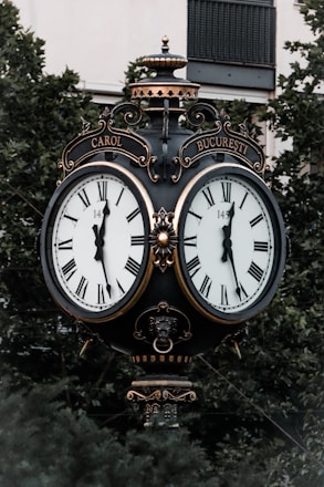 black and white analog clock at 10 00