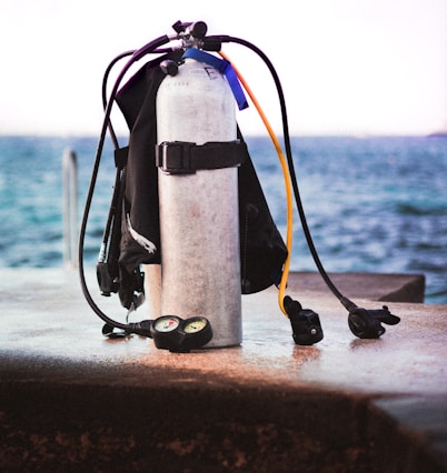 black and white fire extinguisher on brown concrete wall