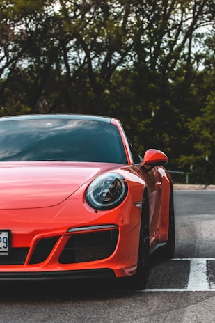 red ferrari 458 italia on road during daytime