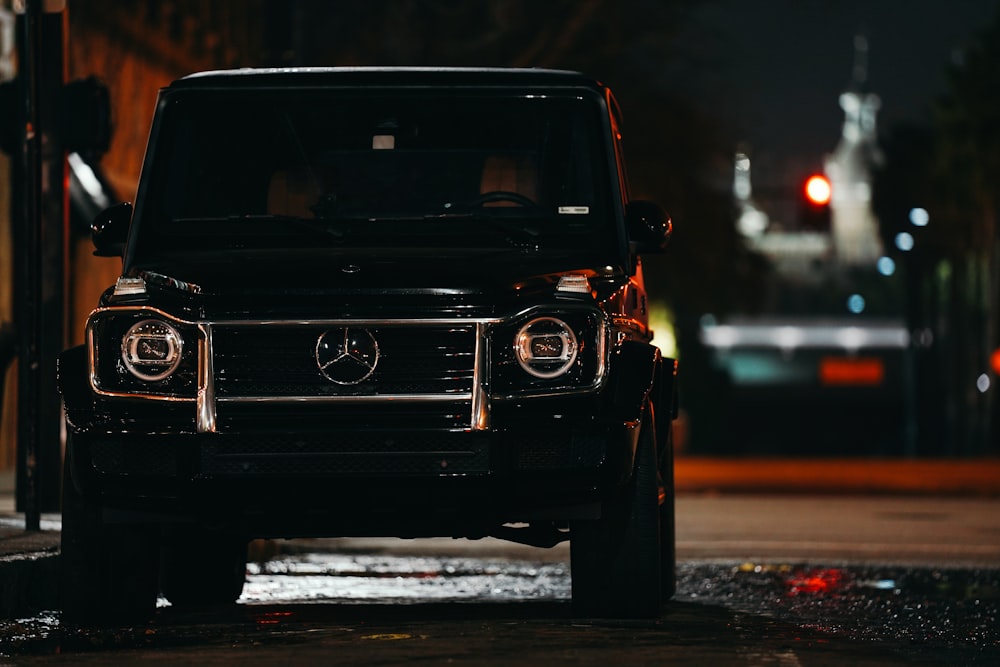 black car on road during night time