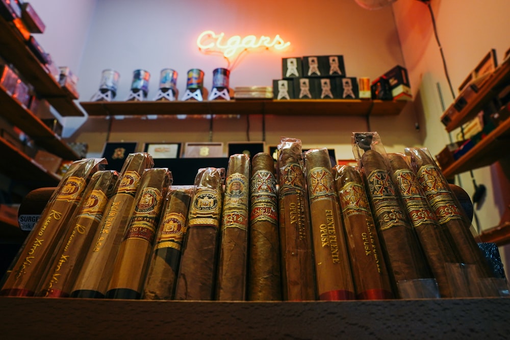 a bunch of cigars that are on a shelf