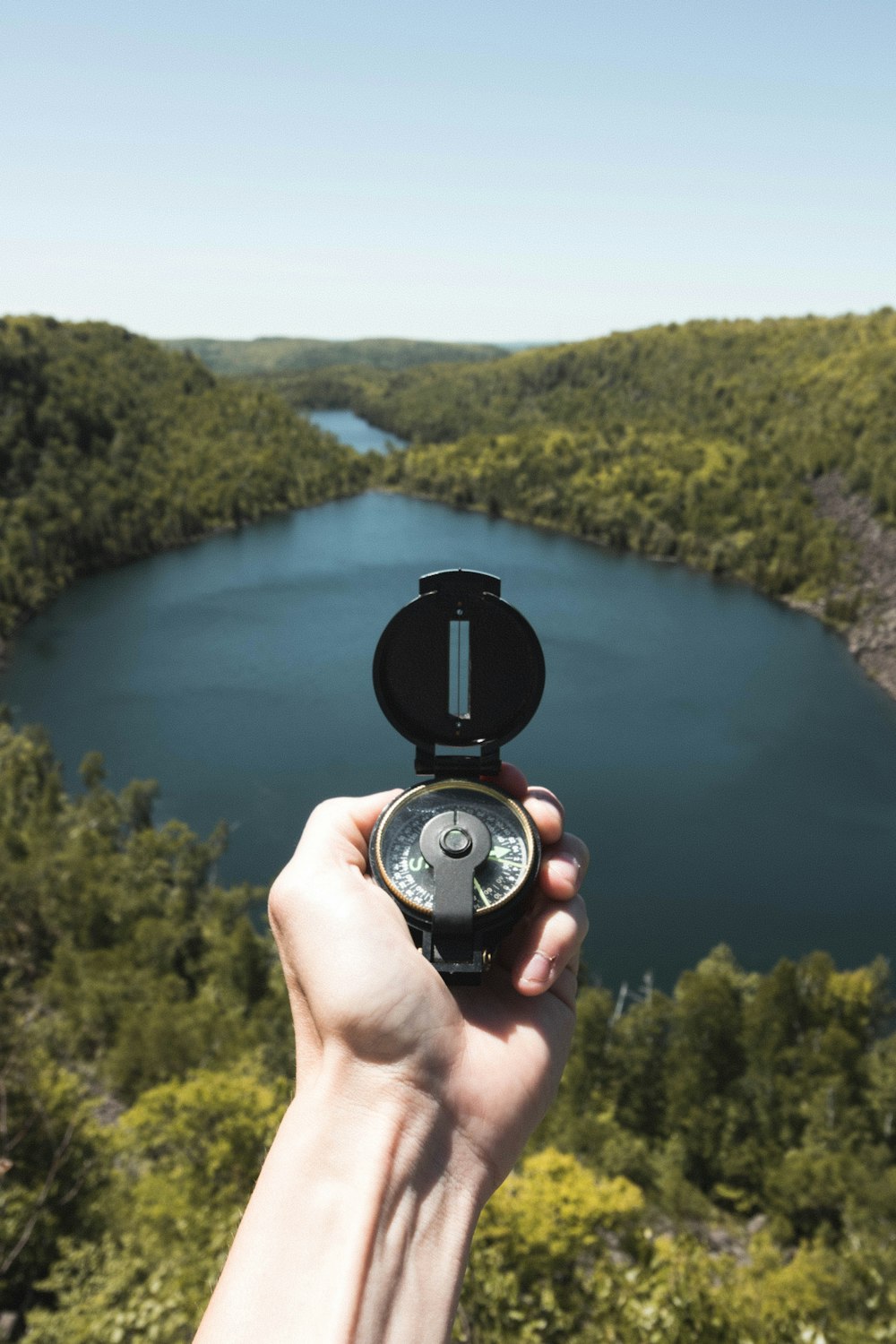 person holding black and silver round analog watch