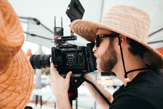 man in black shirt holding black dslr camera