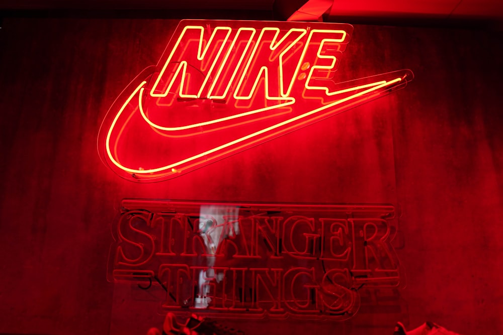 a neon nike sign in a red room
